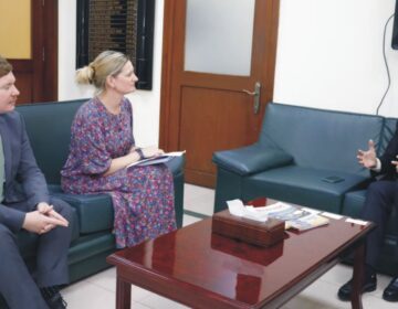 Ali Pervaiz Malik and Joe Moir seated during a meeting at the Ministry of Petroleum, discussing bilateral energy cooperation.