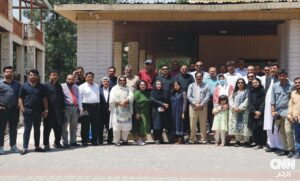Panel of Pakistani health and policy experts speaking at a Murree press briefing, with a banner on non-communicable diseases and images of sugary drinks and snacks in the background.